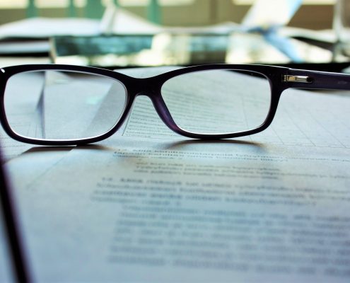 A pair of glasses lying on a document