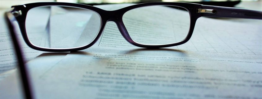 A pair of glasses lying on a document