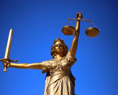 A Lady Justice statue holding scales and a sword