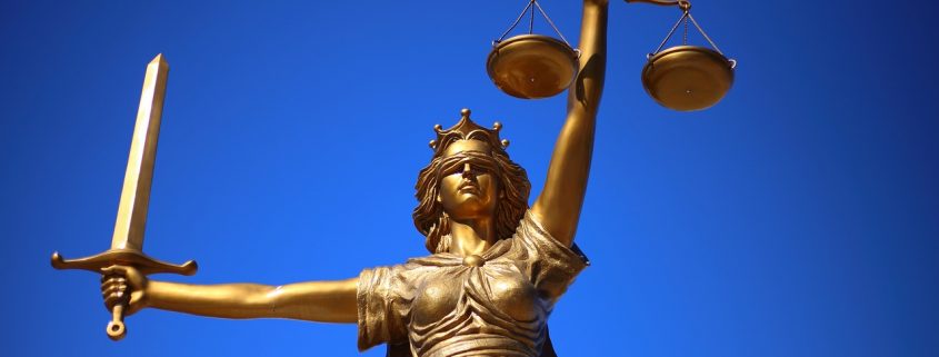 A Lady Justice statue holding scales and a sword