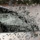 A car's front passenger window shattering as it crashes