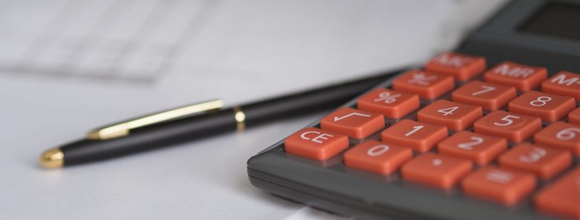 A close up on a calculator and a pen