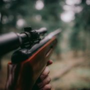 A closeup on a hunting rifle in the woods