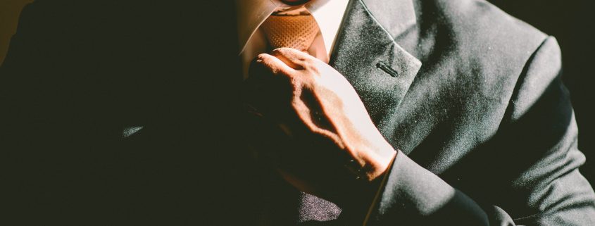 A man fixing his tie