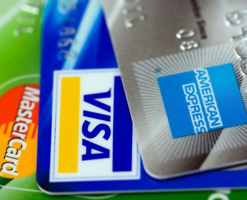 A close up on a MasterCard, a Visa, and an American Express card