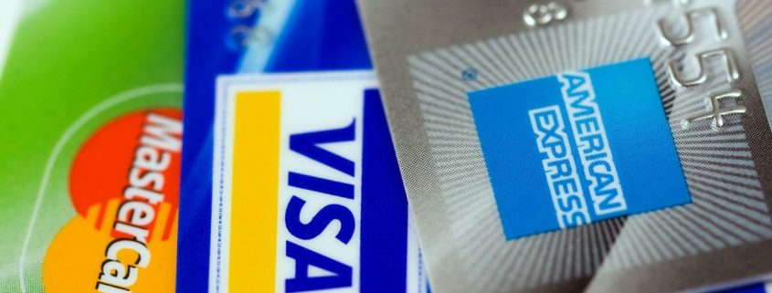 A close up on a MasterCard, a Visa, and an American Express card