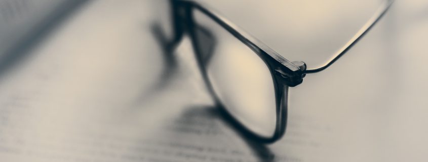 A pair of glasses lying on a document