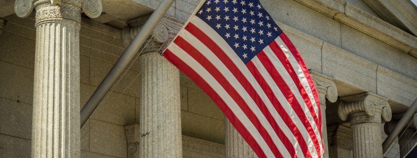 An American flag flying on a courthouse