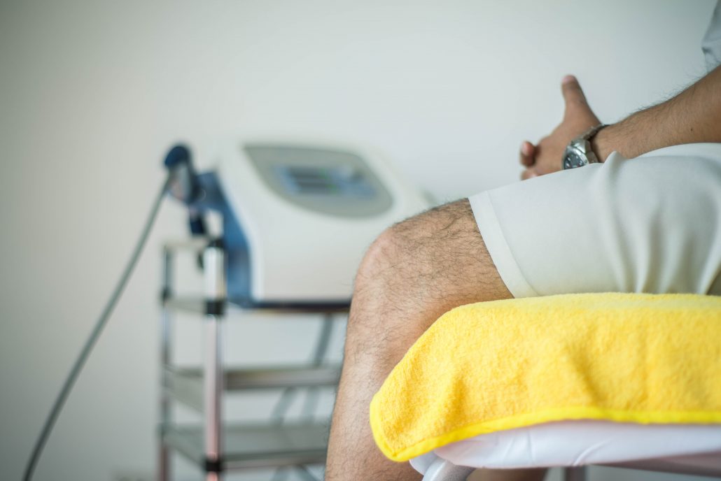 A man waiting in a patient room at a doctor's office