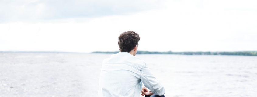 A man looking out at some water