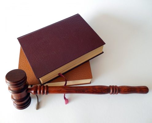 A gavel next to some leather books