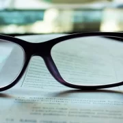 A pair of glasses lying on some documents