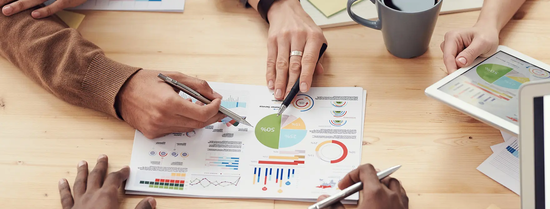 People pointing at a chart in a business meeting