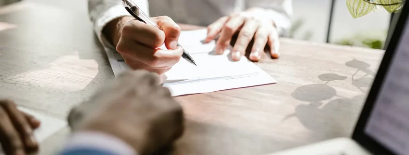 A woman signing a document