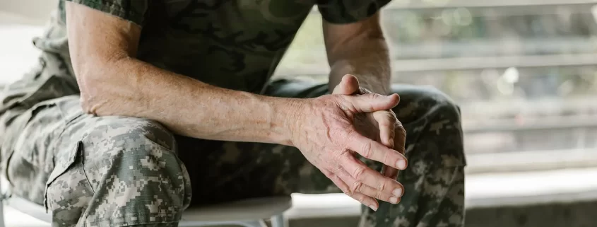 A veteran in army fatigues sitting