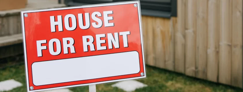 A House For Rent sign outside of a house