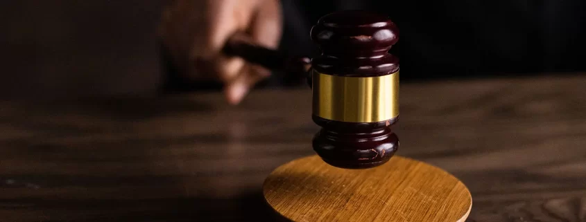 A judge pounding a gavel on a sound block