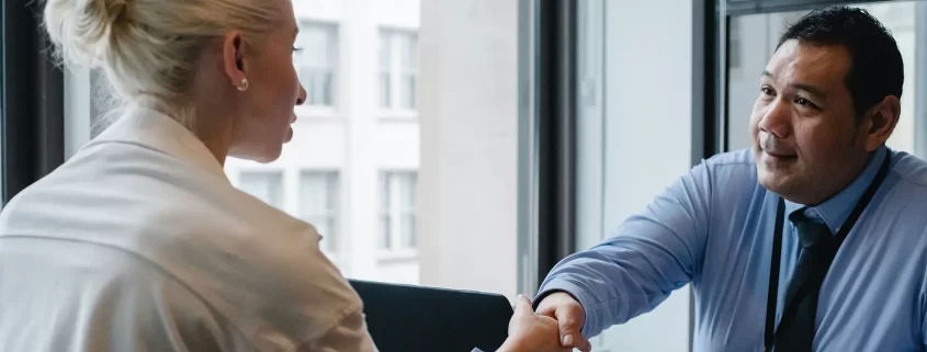 An employer shaking hands with an employee