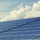 A photo of solar panels under a blue sky.