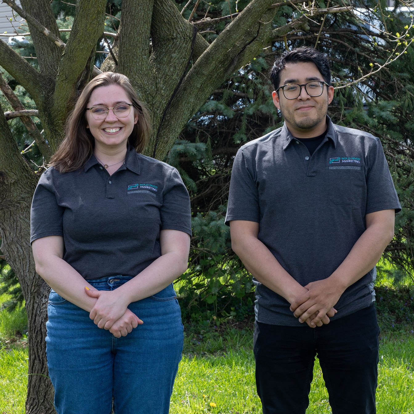 Two employees from Bold River Marketing standing together and smiling