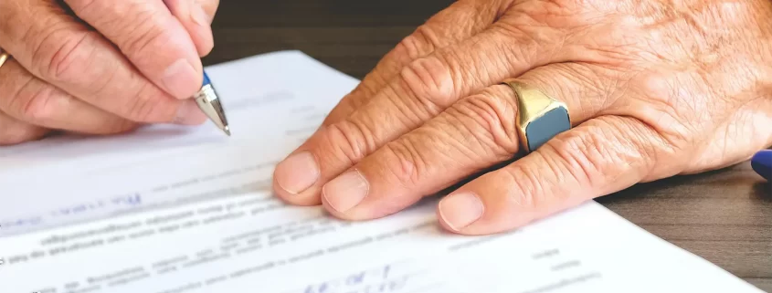 A man signing papers to dissolve a trust
