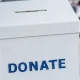 hands holding a nonprofit donation box