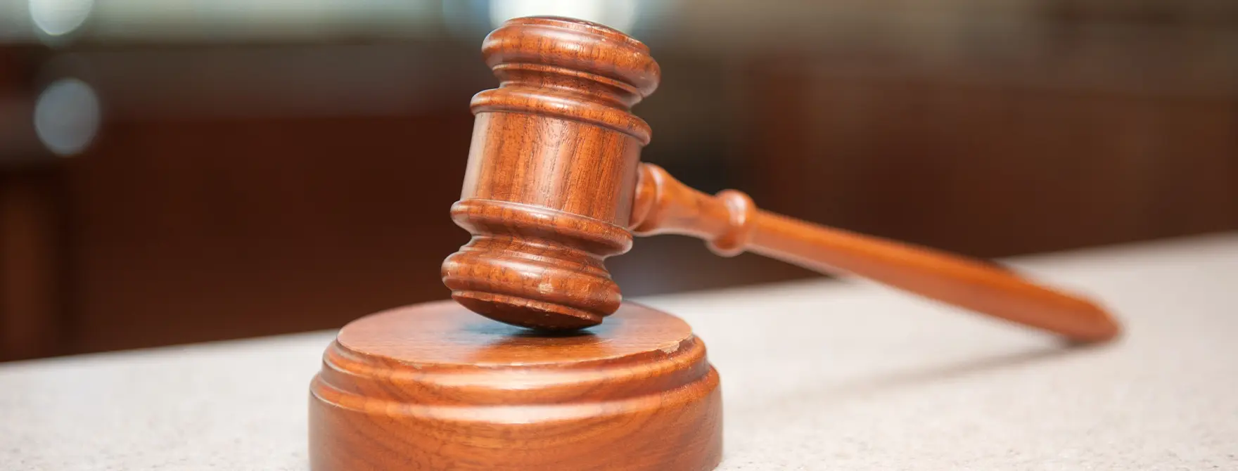 A gavel resting on a sound block