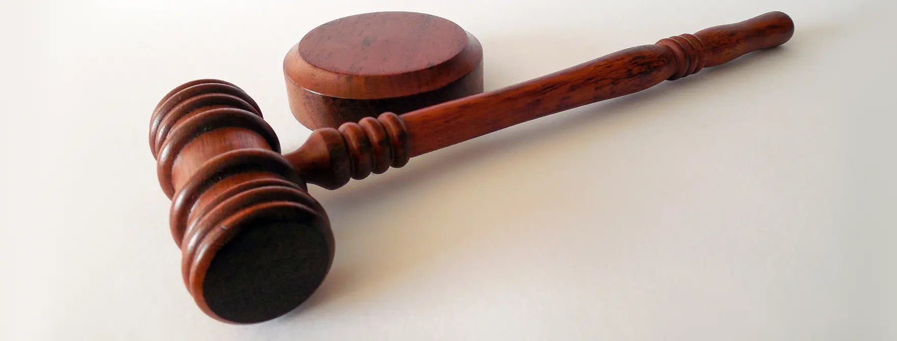 A gavel resting next to a sound block