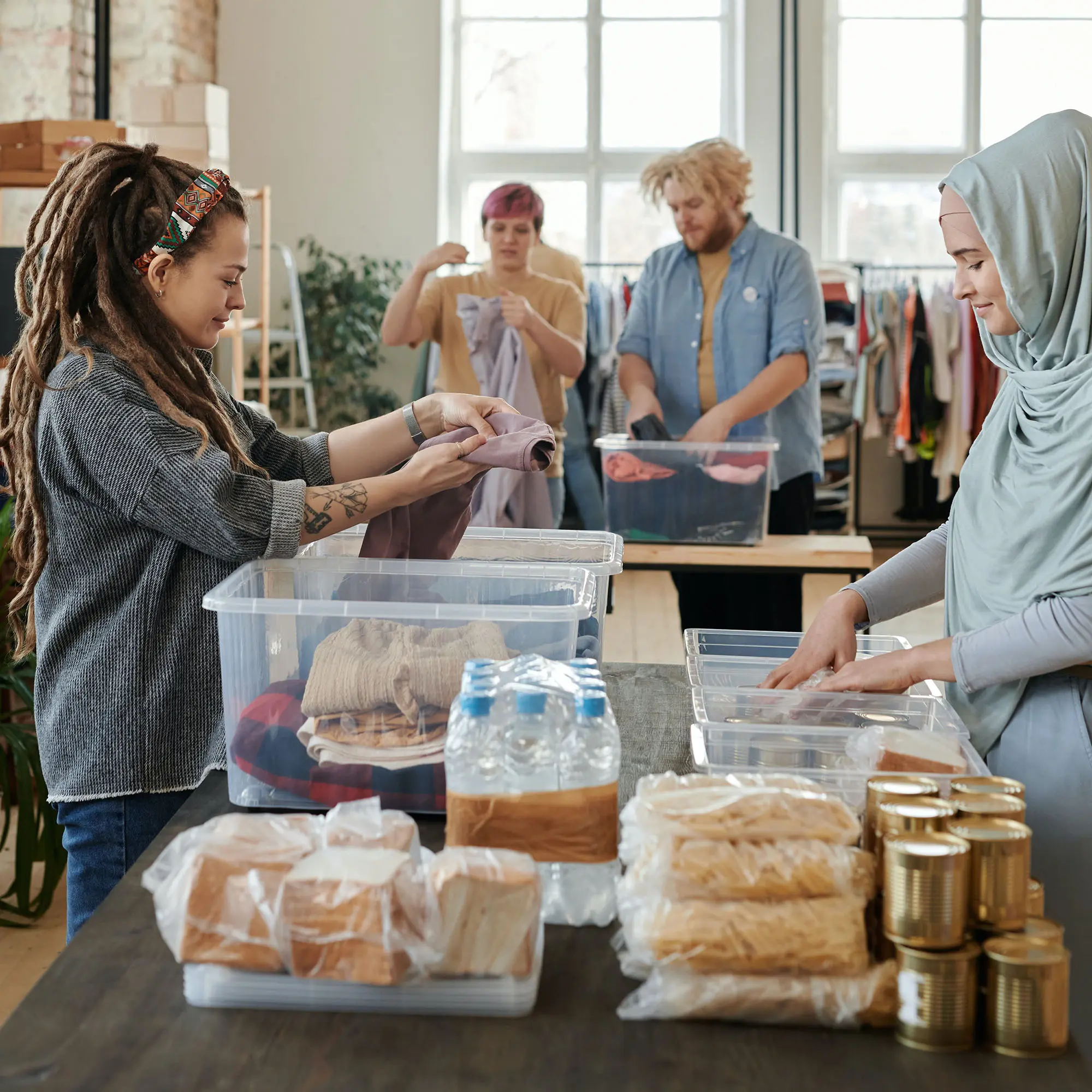 Volunteers folding clothing and distributing supplies