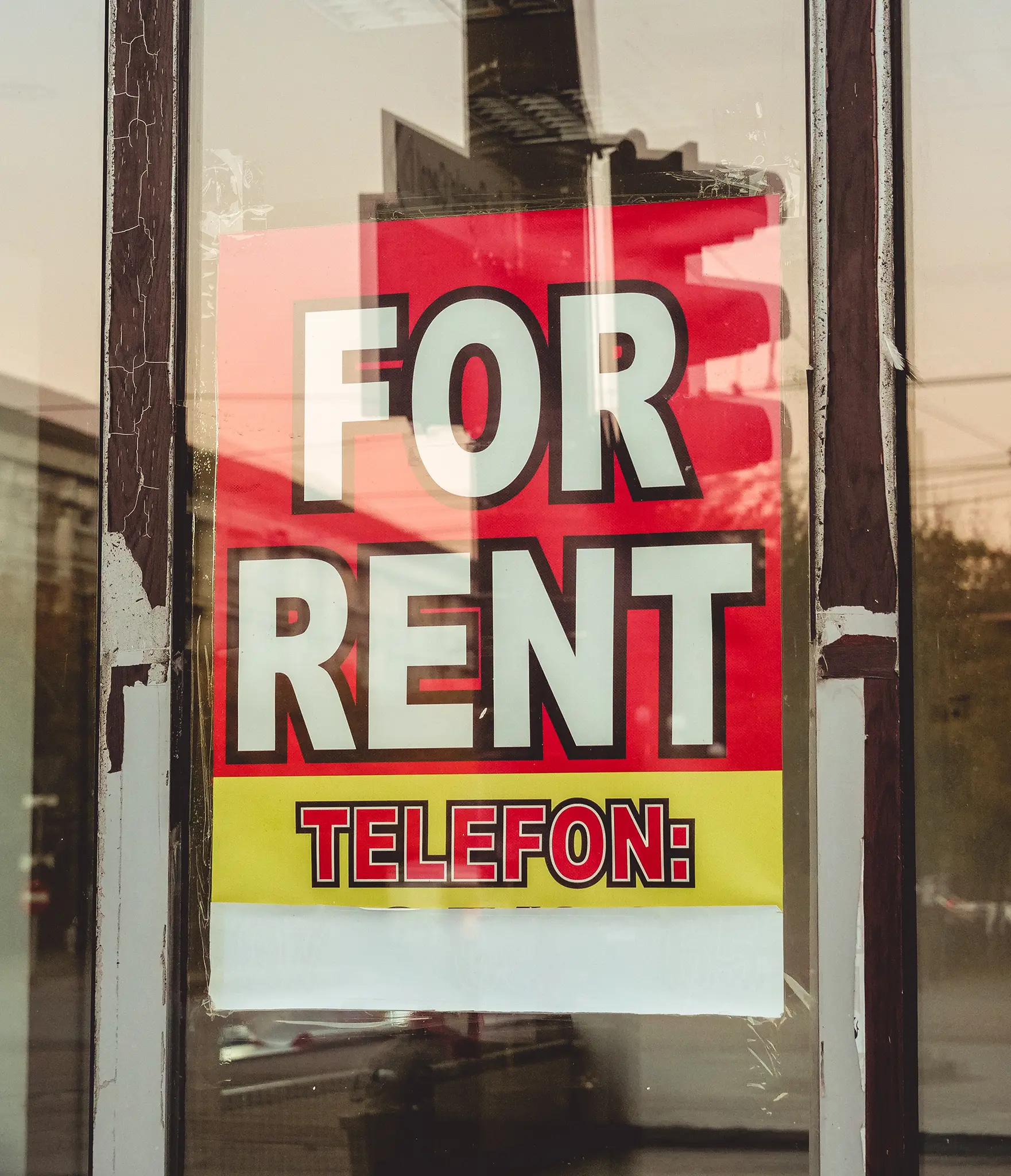 A For Rent sign in a window