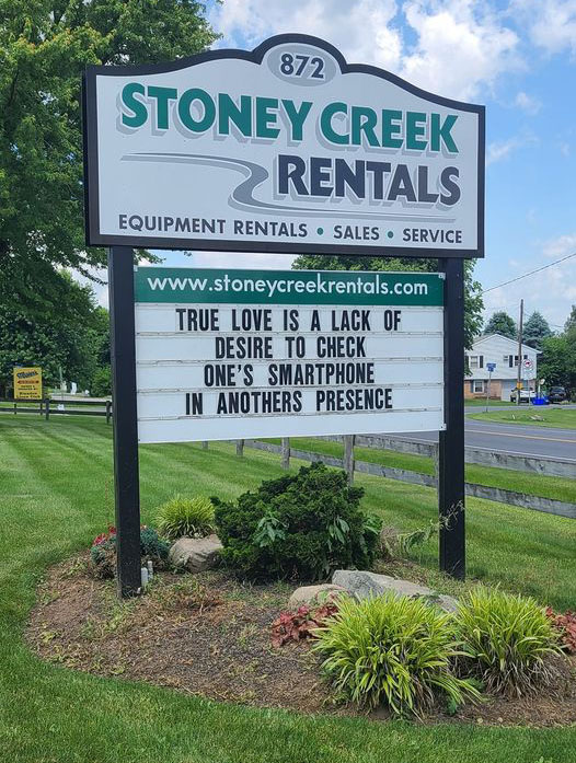 The front sign from Stoney Creek Rentals. It says "True love is a lack of desire to check one's smartphone in anothers presence"