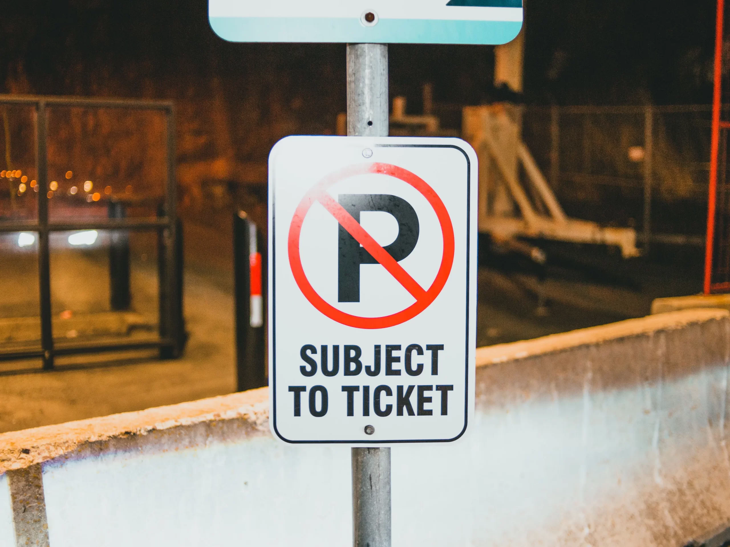 A no parking sign that says "Subject to ticket"