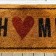 A welcome mat that says "Home" with a heart as the "o"