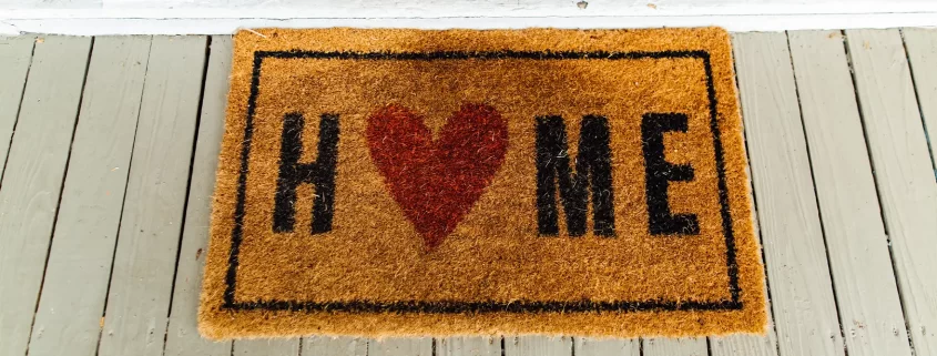 A welcome mat that says "Home" with a heart as the "o"