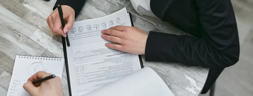 A woman signing a financial document