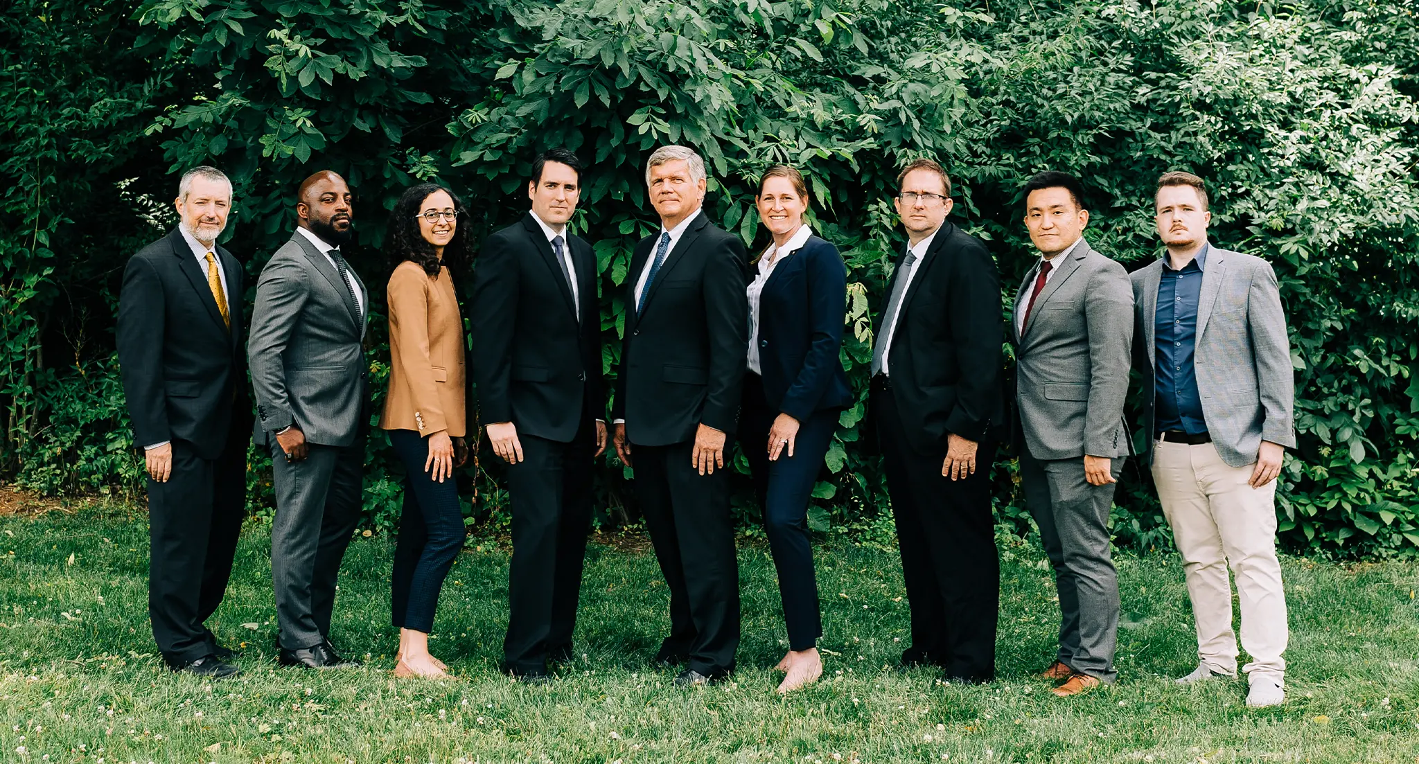 A group photo of the 9 attorneys of Cornerstone Law Firm. From left to right, the order is: Attorney Otto, Attorney Browne, Attorney Caloia, Attorney Ready, Attorney Distasio, Attorney Rauch-Mannino, Attorney Winter, Attorney Hong, and Attorney Mayle.