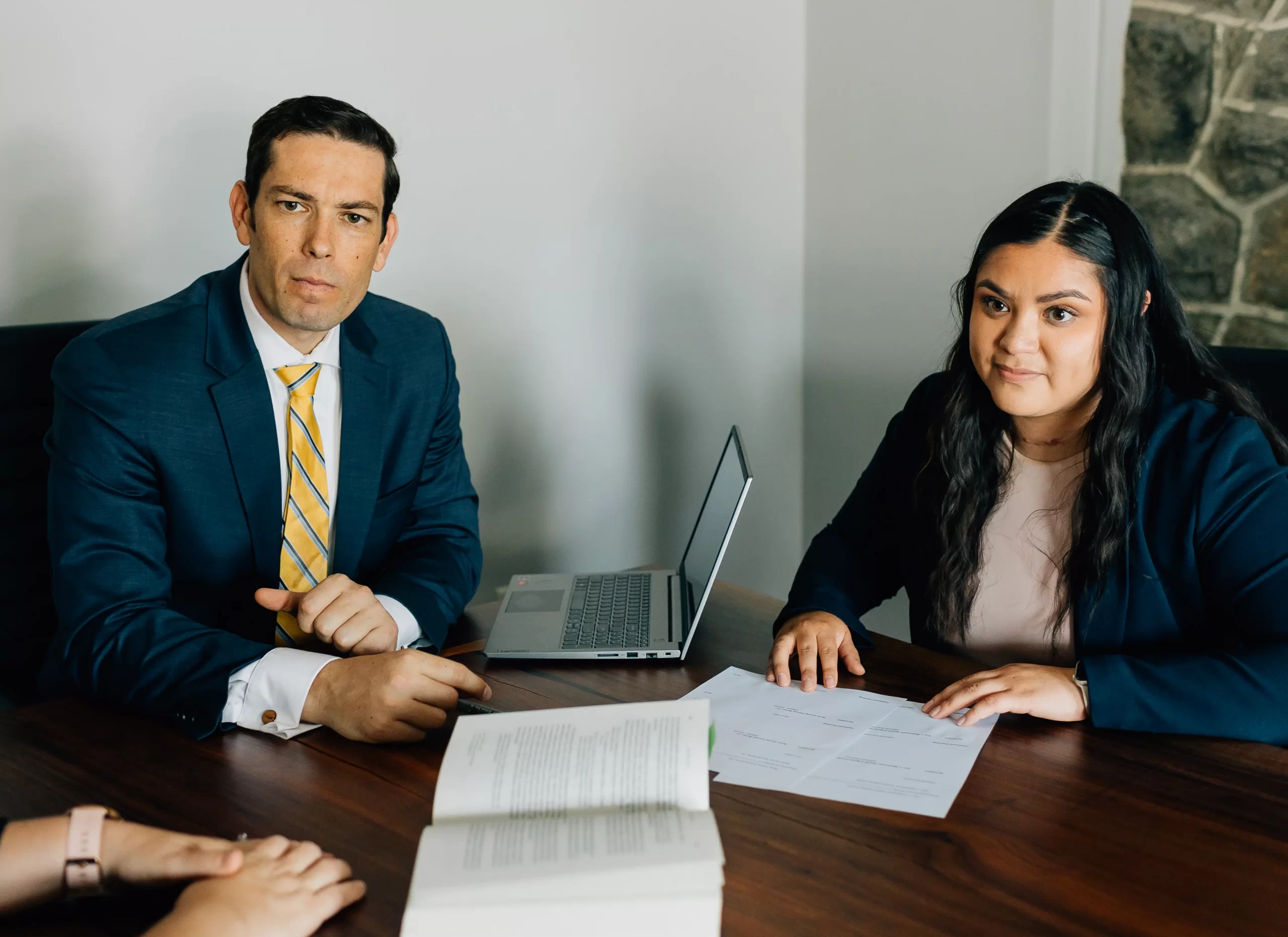 Two Cornerstone staff sitting at a conference table, having a meeting.