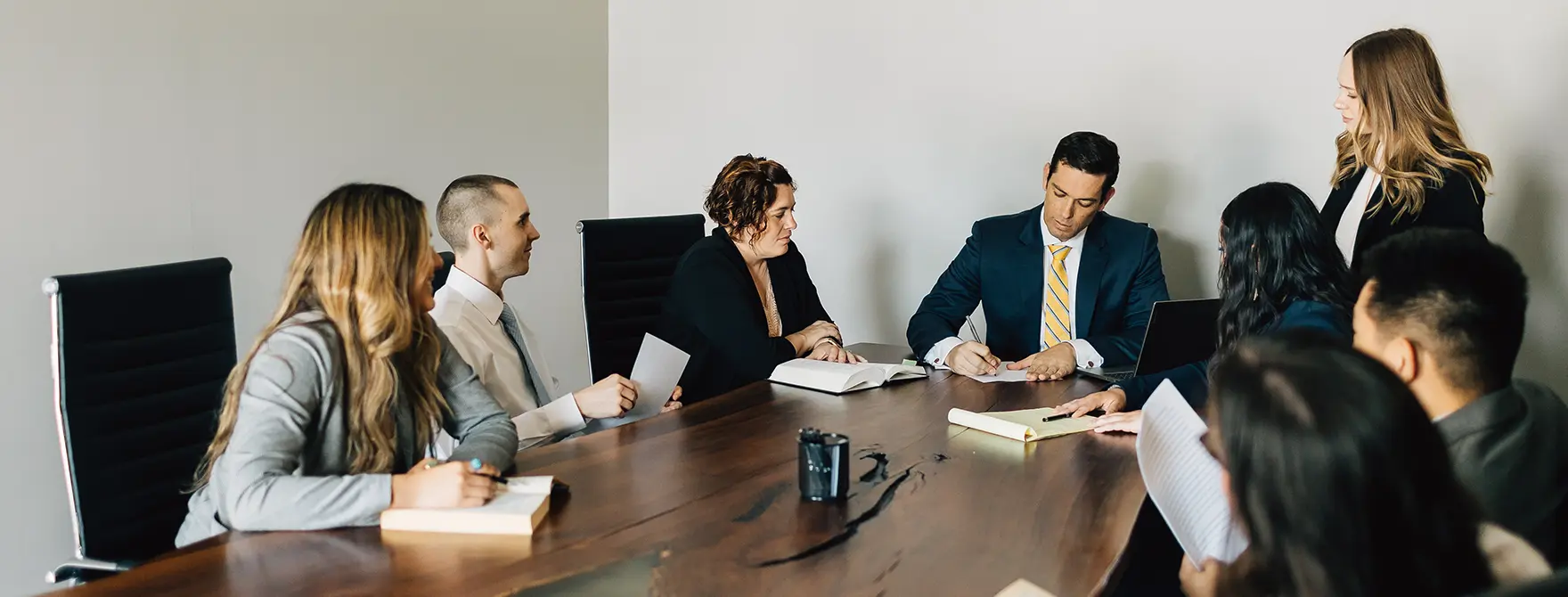 Eight Cornerstone employees having a meeting around a conference table.