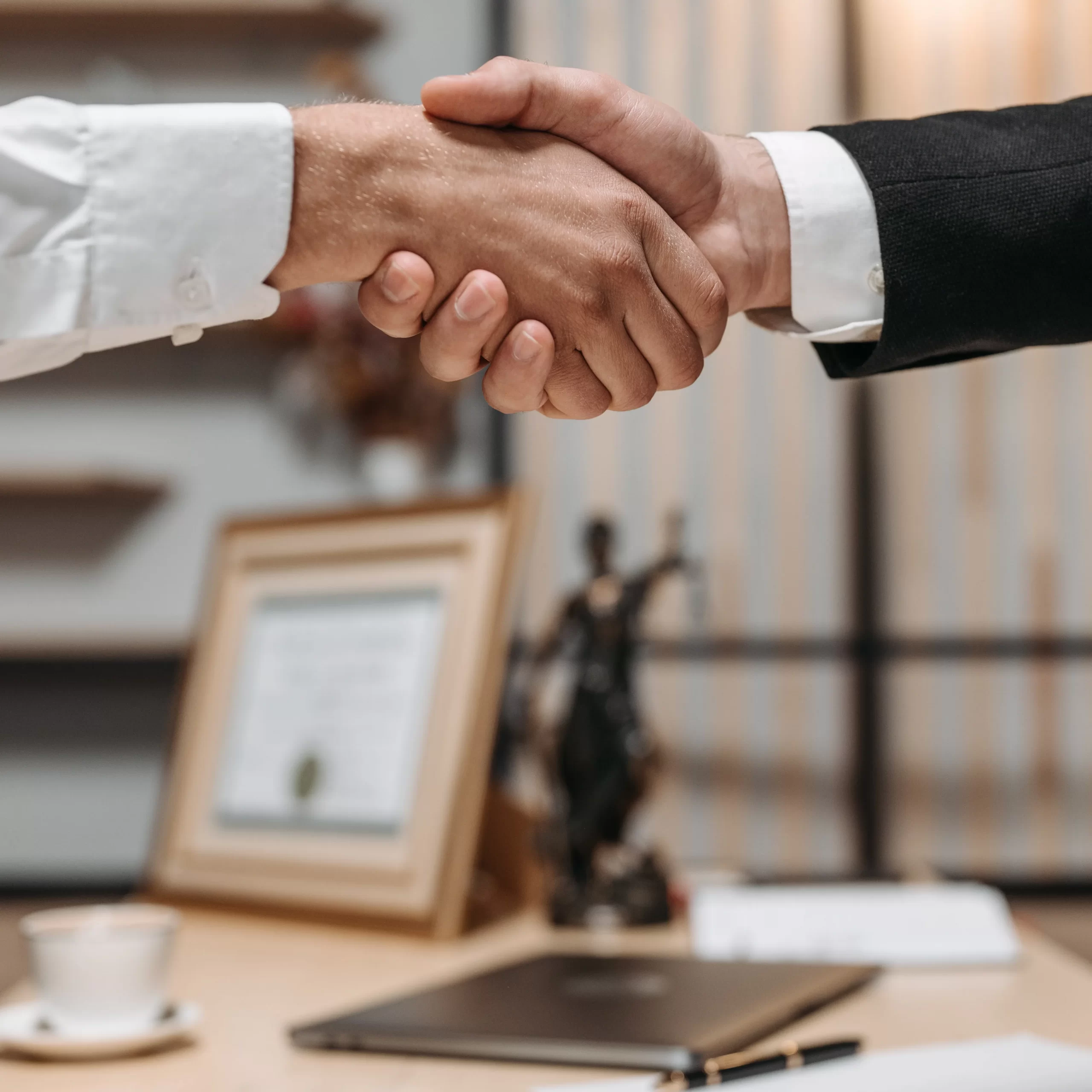 Close up on a handshake in a lawyer's office