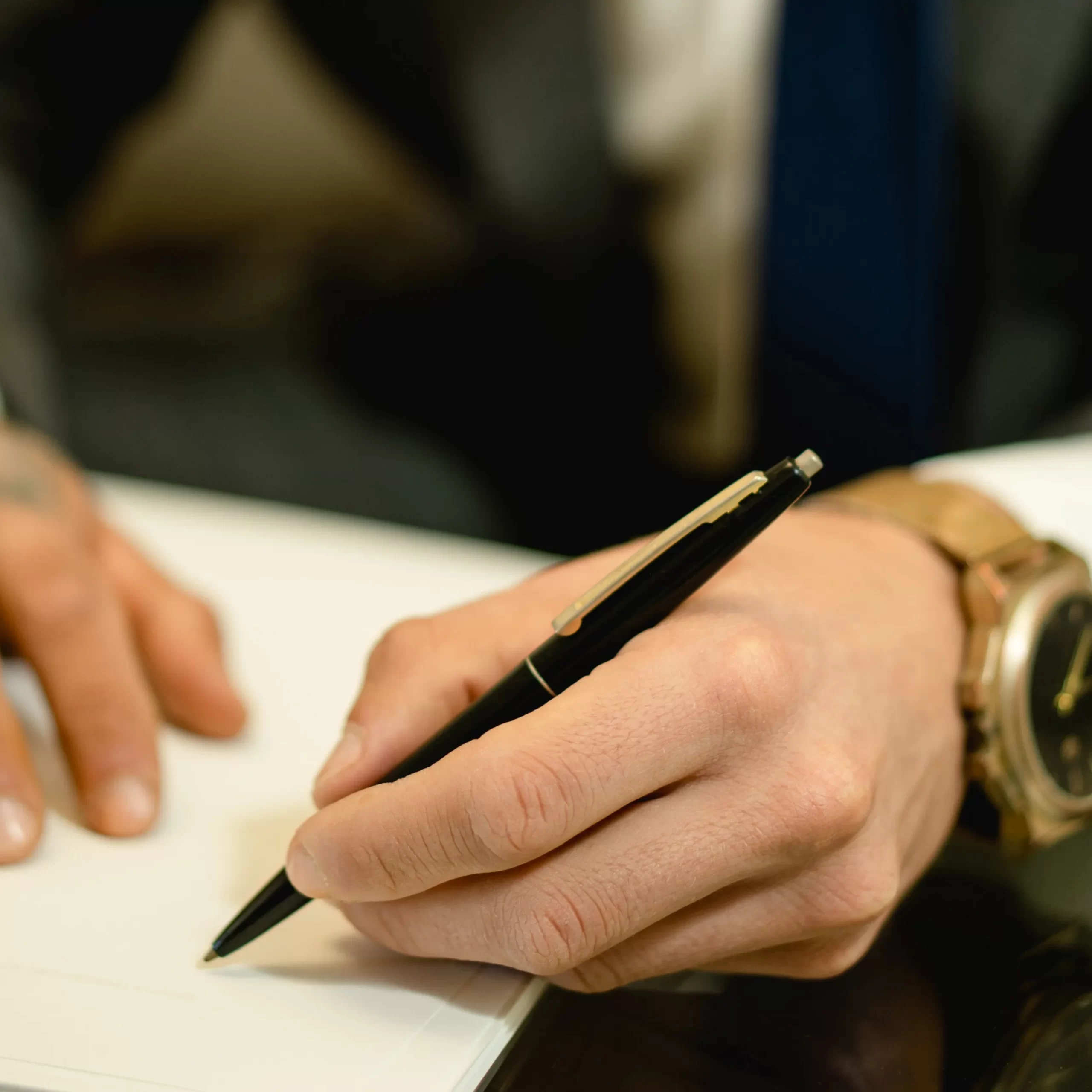 Someone signing a trust document.