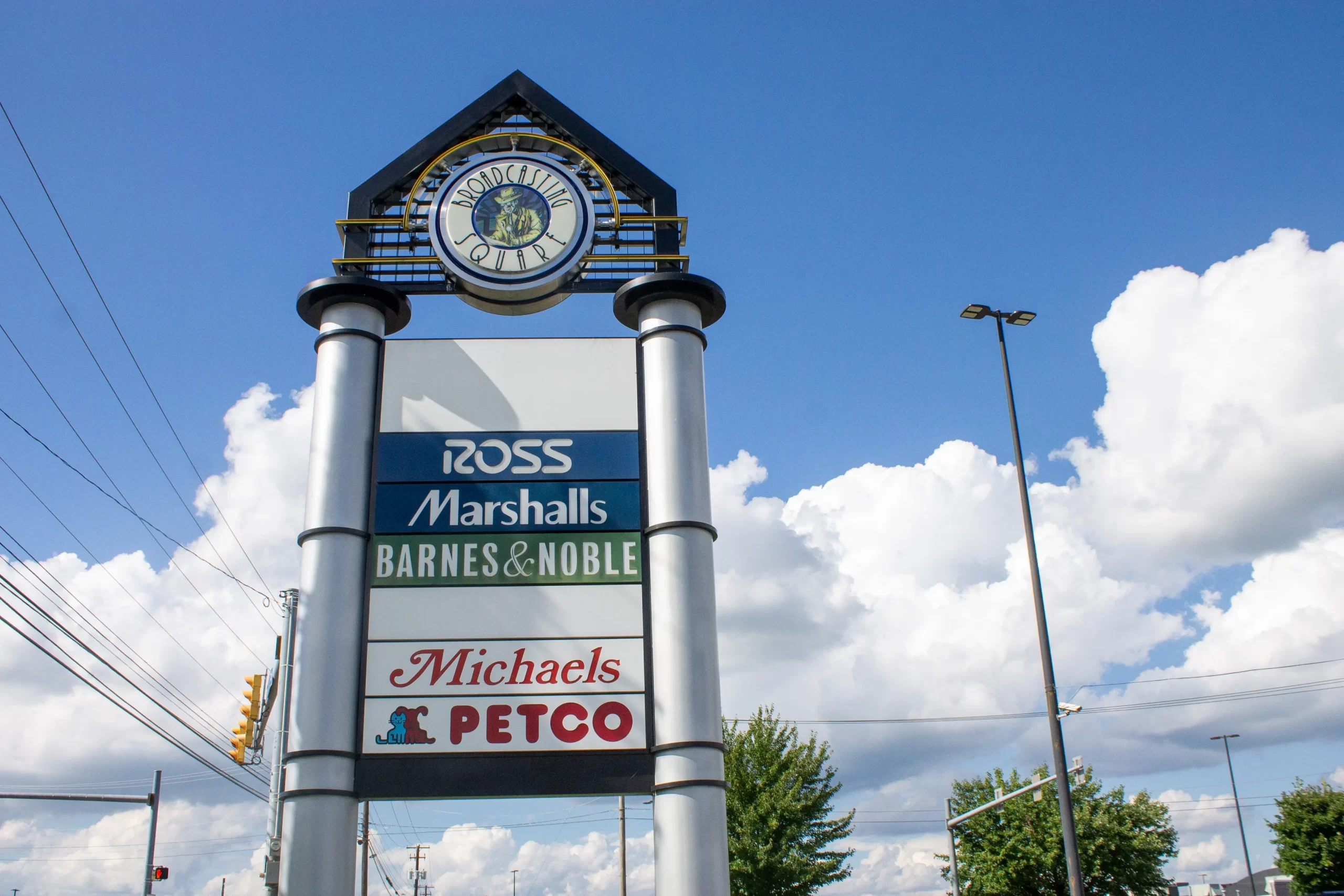 A photo of the different shop signs at Broadcasting Square on a sunny day.