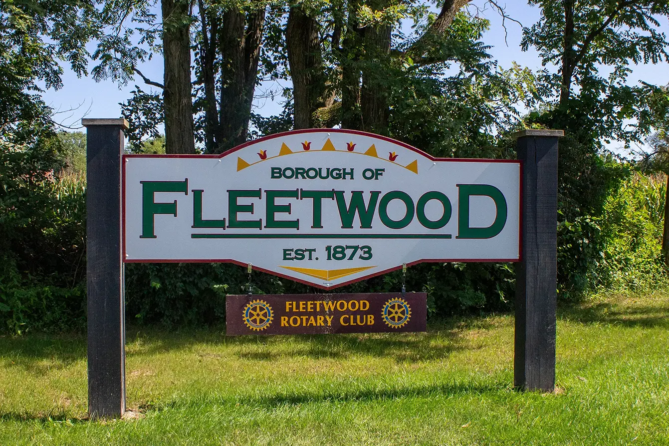 A photo of the Borough of Fleetwood sign with the Fleetwood Rotary Club sign hanging underneath.