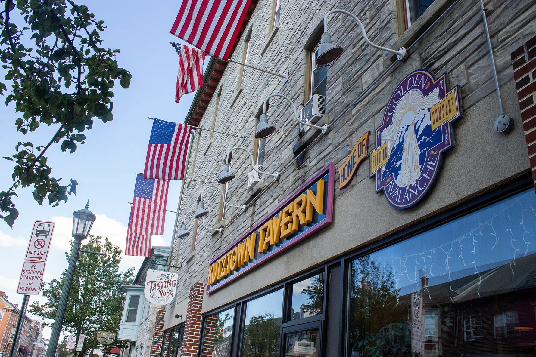 A photo of the Kutztown Tavern sign on Main Street, taken from an artsy angle.