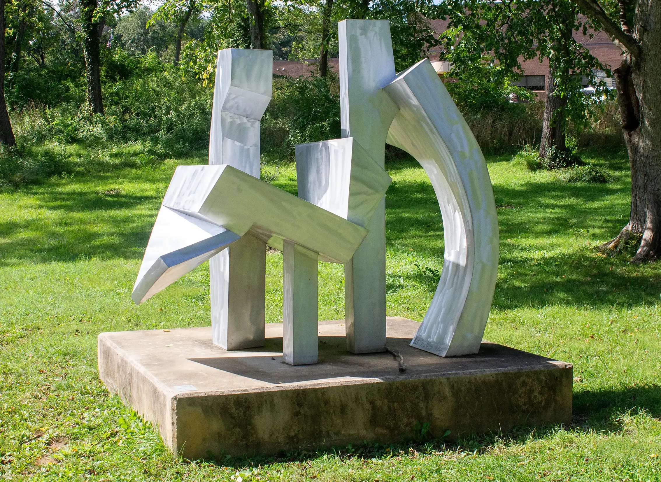 A silver, metal statue at the Reading Museum park.