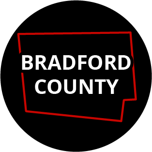 The words "Bradford County" in a black circle with red outline of the county behind it. The image links to a page listing the county's Magisterial District Courts.