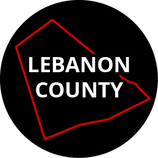 The words "Lebanon County" in a black circle with red outline of the county behind it. The image links to a page listing the county's Magisterial District Courts.