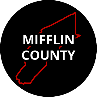 The words "Mifflin County" in a black circle with red outline of the county behind it. The image links to a page listing the county's Magisterial District Courts.