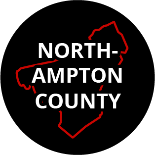 The words "Northampton County" in a black circle with red outline of the county behind it. The image links to a page listing the county's Magisterial District Courts.