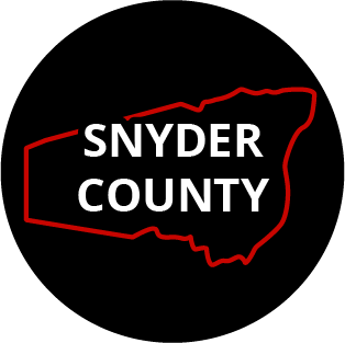 The words "Snyder County" in a black circle with red outline of the county behind it. The image links to a page listing the county's Magisterial District Courts.