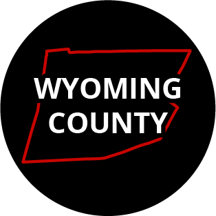 The words "Wyoming County" in a black circle with red outline of the county behind it. The image links to a page listing the county's Magisterial District Courts.